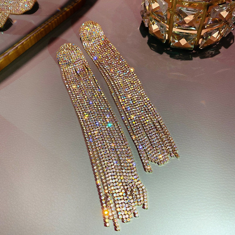 Women's sparkling rhinestone drop and tassel earrings, perfect statement jewelry for formal occasions.