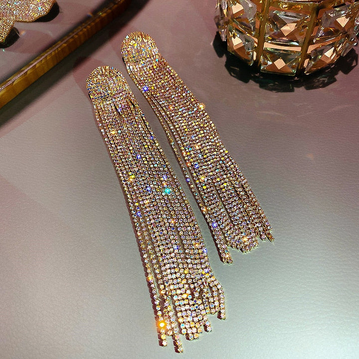 Women's sparkling rhinestone drop and tassel earrings, perfect statement jewelry for formal occasions.