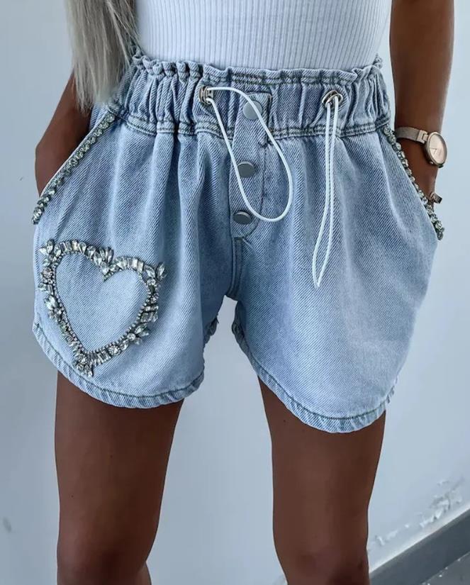 Women's dazzling rhinestone heart denim shorts for summer parties. Glam fashion statement with sparkle.