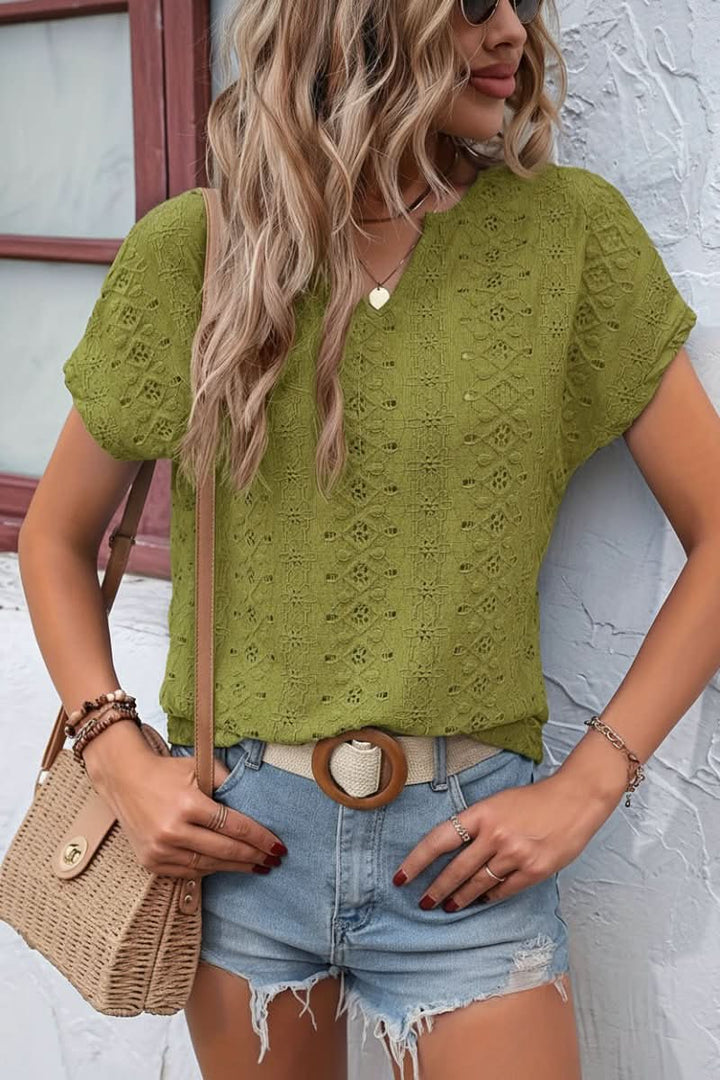 Trendy women's casual t-shirt with intricate eyelet details and a distinctive notched collar design.