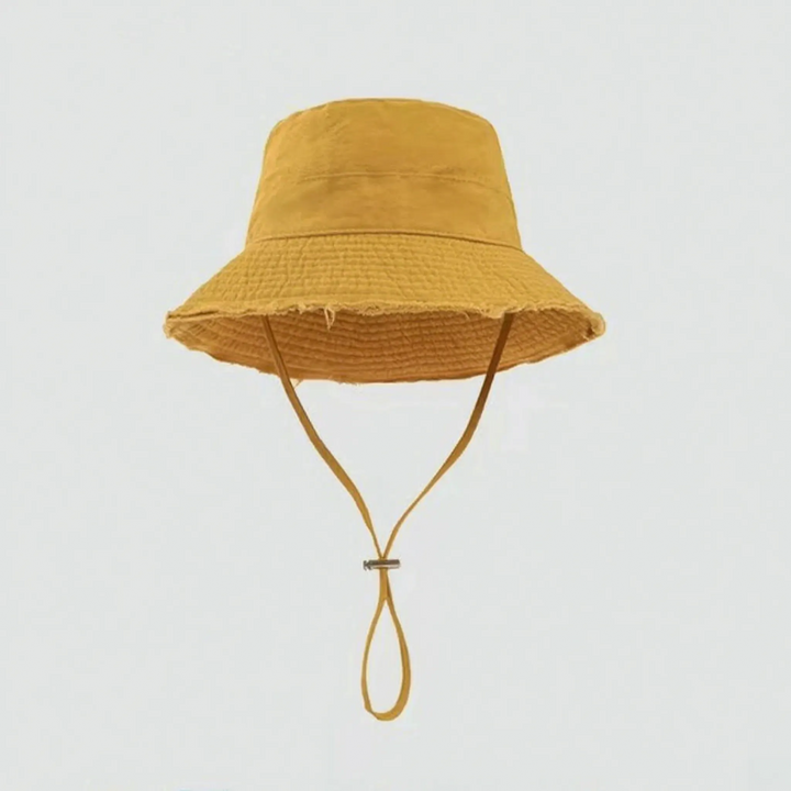 Women's distressed summer bucket hat, an essential travel accessory with an adjustable chin strap & sun shade.