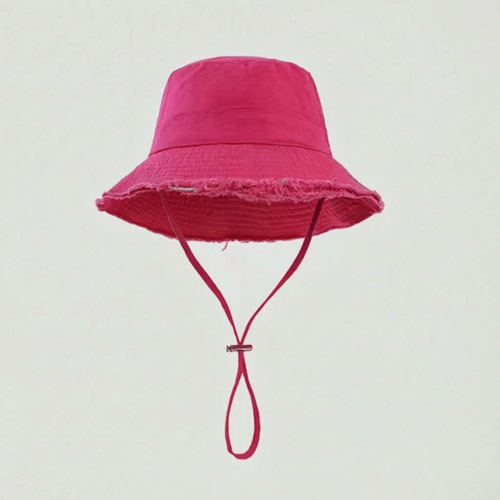 Women's frayed brim bucket hat, distressed look, adjustable chin strap, great for summer, beach, or travel.