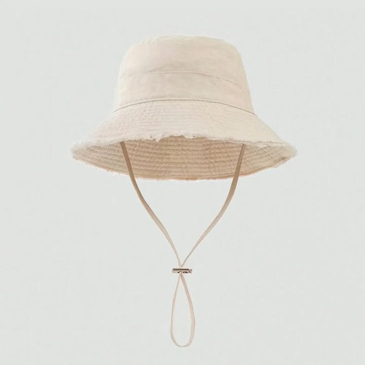 Summer-ready women's distressed bucket hat featuring a sturdy chin strap and on-trend frayed detailing.