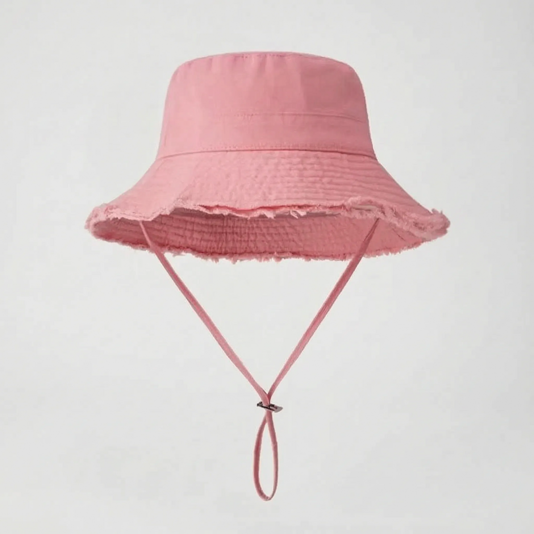 Boho-chic women's distressed bucket hat, perfect for beach outings, with a functional chin strap.