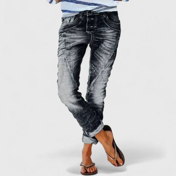 Trendy women's wide-leg distressed denim pants, mid-rise for a relaxed, casual, everyday fashion.