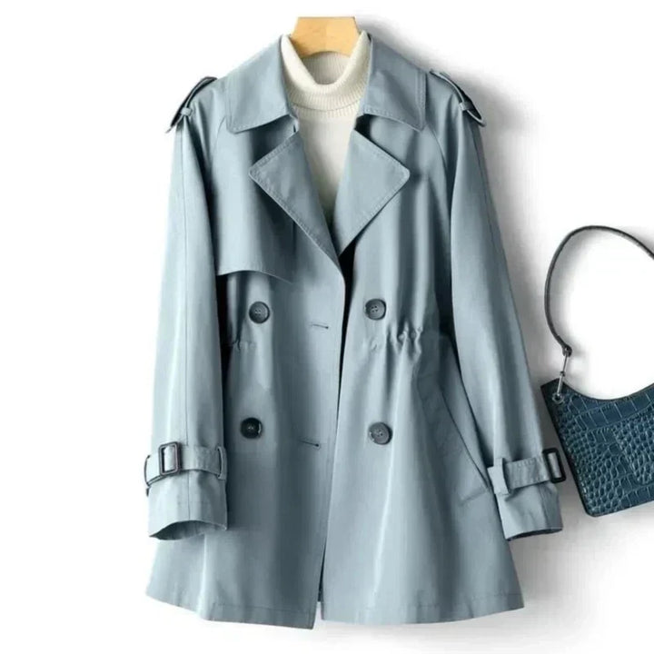 Classic women's belted double-breasted trench coat. Stylish outerwear with adjustable cuffs for spring/fall.