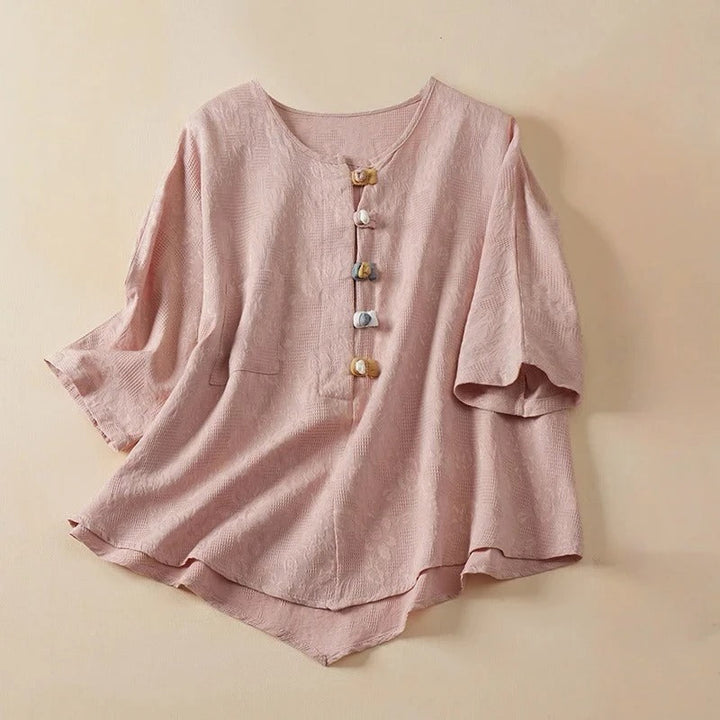 Casual chic women's Eden Blouse with stylish knotted buttons. Perfect button-up shirt for versatile wear.