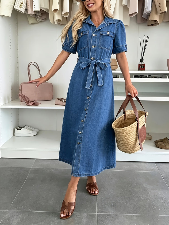 Fashionable women's blue denim dress with a button-front, cinched belt, and on-trend puff sleeves for spring/summer.