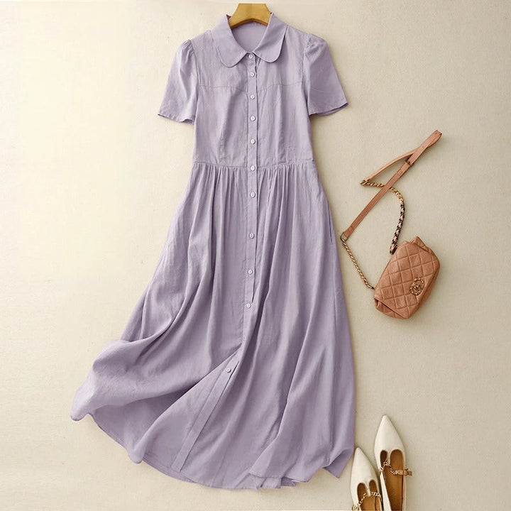 Elegant women's flowy button-front summer midi dress, ideal for casual outings or vacation. Comfortable and stylish.