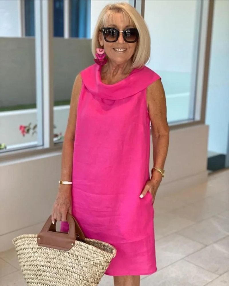 Women's effortless cowl neck shift dress with practical pockets, ideal for casual summer wear. Relaxed fit.