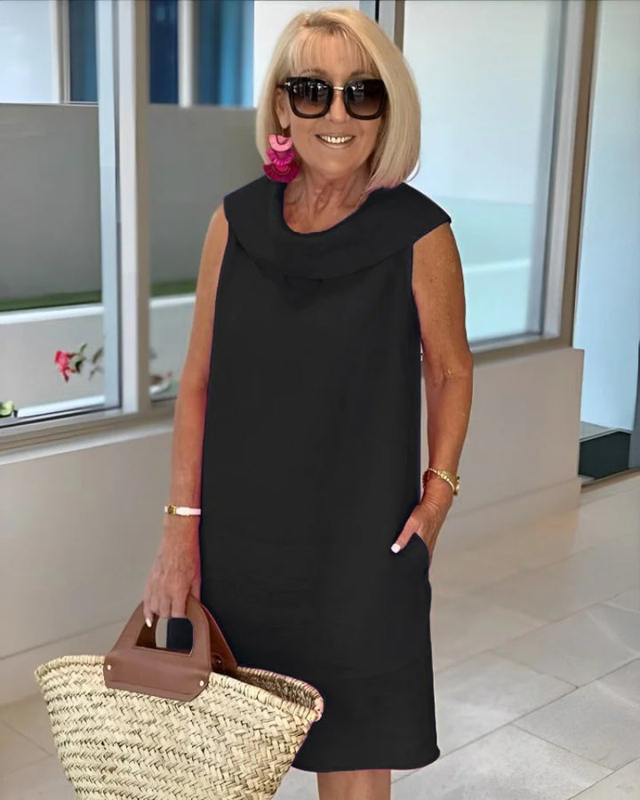 Relaxed fit sleeveless shift dress for women, featuring a stylish cowl neck and convenient pockets for comfort.