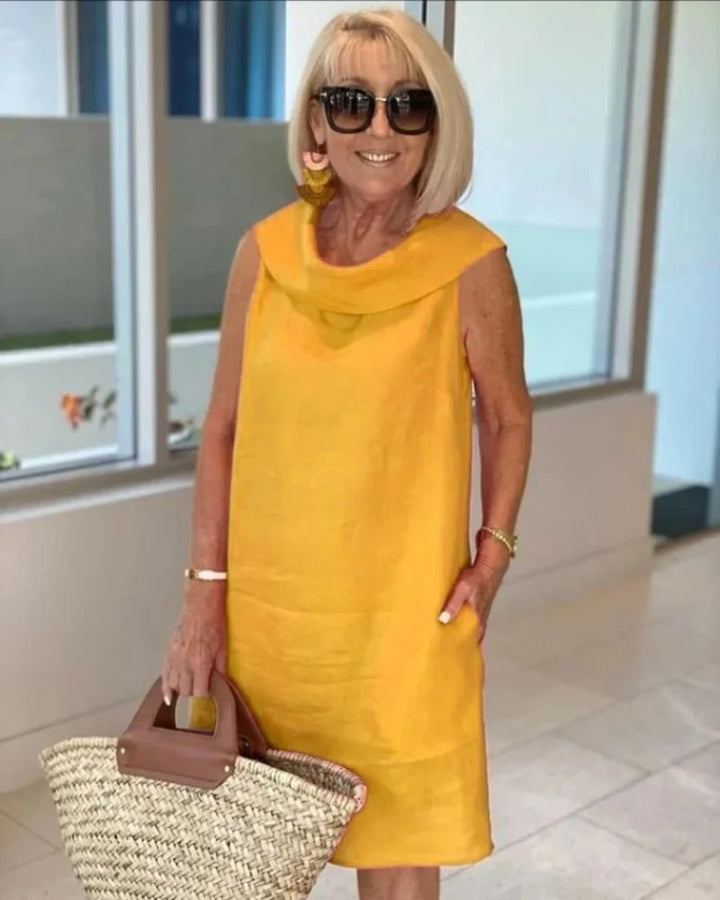 Effortless women's sleeveless cowl neck shift dress with handy pockets, perfect for stylish casual summer outfits.