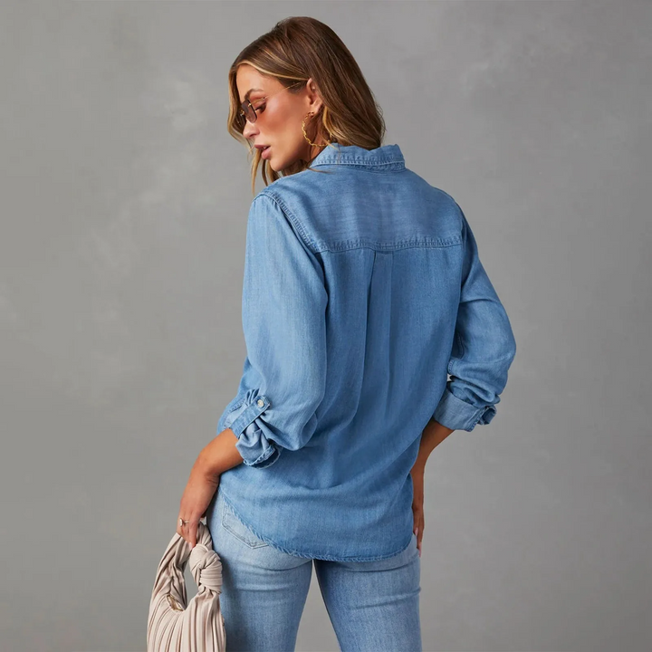 Stylish women's relaxed-fit denim button-up shirt, ideal for everyday casual wear. Long sleeve design.