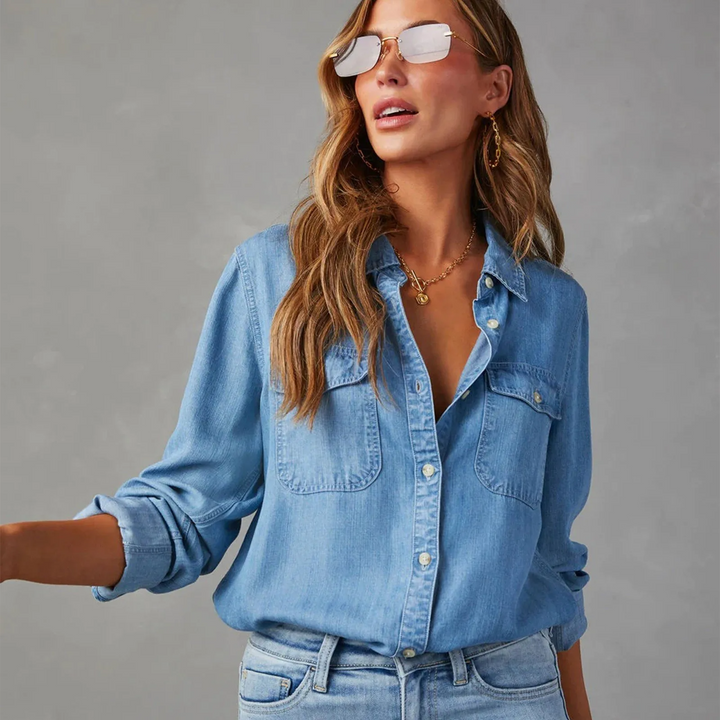 Effortless women's denim button-up shirt with long sleeves, offering a comfortable relaxed fit for any casual occasion.