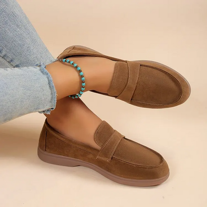 Classic brown women's slip-on loafers, providing cushioned comfort and a versatile, polished style.