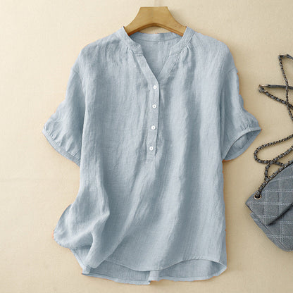 Casual blue V-neck button-up blouse for women, features rolled long sleeves & relaxed fit. Ideal spring/summer top.