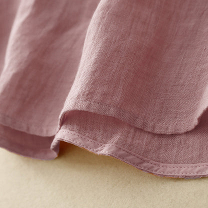 Effortless women's pink V-neck blouse, a versatile long sleeve top with button-up front & relaxed fit for any season.