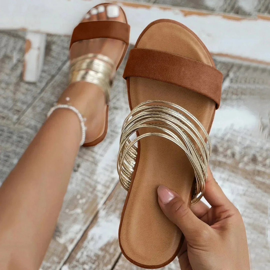 Comfortable women's slip-on flat sandals with open toe design, perfect for casual summer wear.