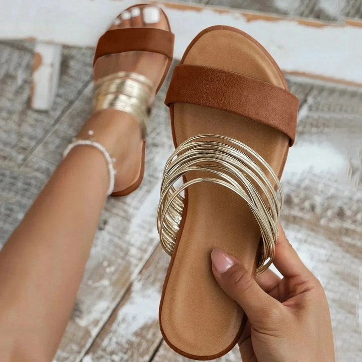 Comfortable women's slip-on flat sandals with open toe design, perfect for casual summer wear.