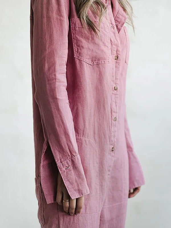 Model wears a women's long sleeve button-up jumpsuit. Chic, relaxed fit for a comfortable, stylish look.