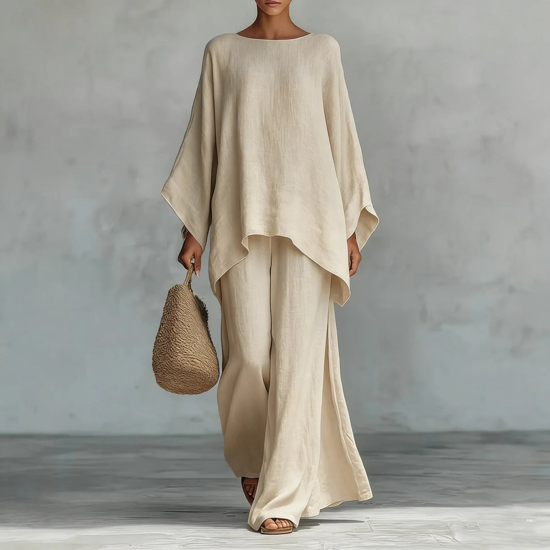 Woman modeling a fashionable asymmetrical two-piece pant set with wide-leg pants. Perfect for loungewear.