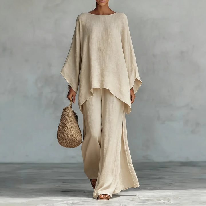 Woman modeling a fashionable asymmetrical two-piece pant set with wide-leg pants. Perfect for loungewear.