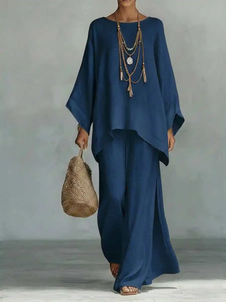 Chic women's asymmetrical wide-leg two-piece pant set. Matching top and bottom for casual elegance.