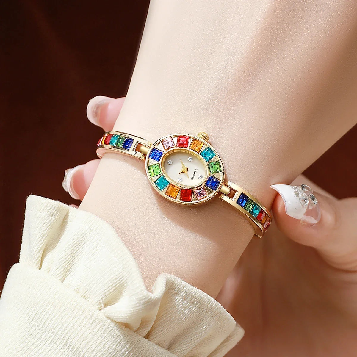 Close-up of Aurora gemstone watch, highlighting the elegant oval dial & sparkling gems; a beautiful women's jewelry watch.