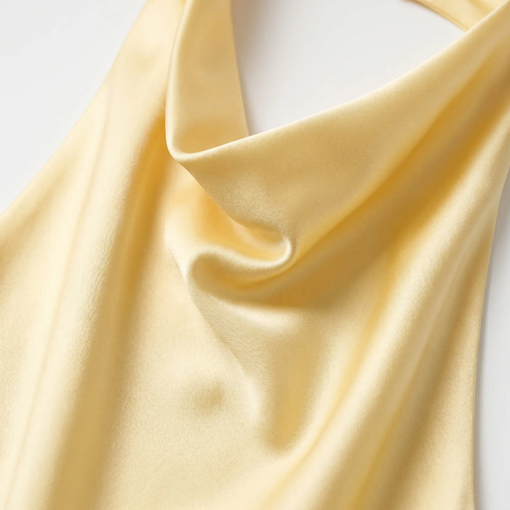 Dressy women's solid color halter top with a flattering draped neckline, suitable for summer parties.