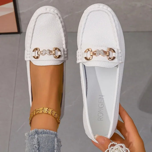 Women's elegant black loafers with sparkling crystal chain detail.