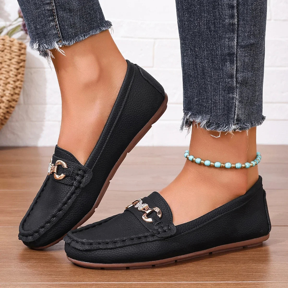 Black women's loafers with crystal chain, offering a versatile polished look.