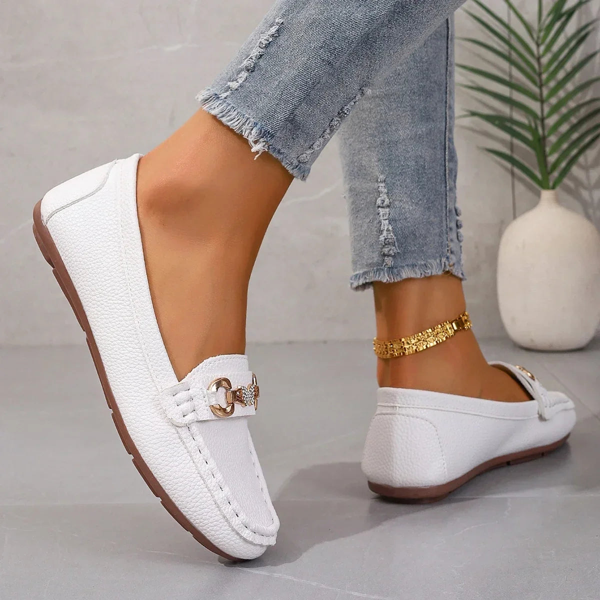 Elegant women's footwear: slip-on loafers with decorative crystal chain.