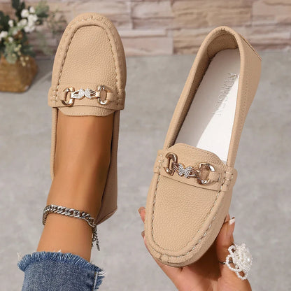 Polished black women's loafers with unique crystal chain embellishment.