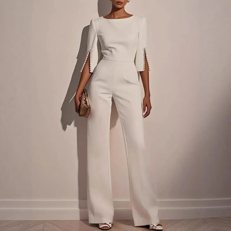 Women's elegant black tailored jumpsuit with sophisticated pearl cuffs, perfect for formal evening events.