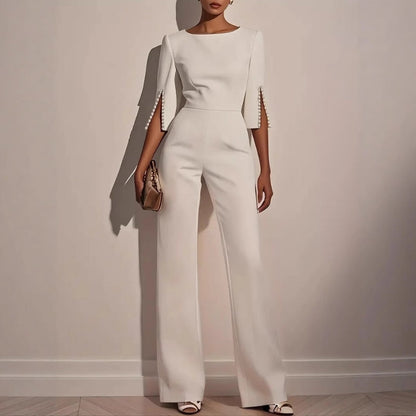 Women's elegant black tailored jumpsuit with sophisticated pearl cuffs, perfect for formal evening events.