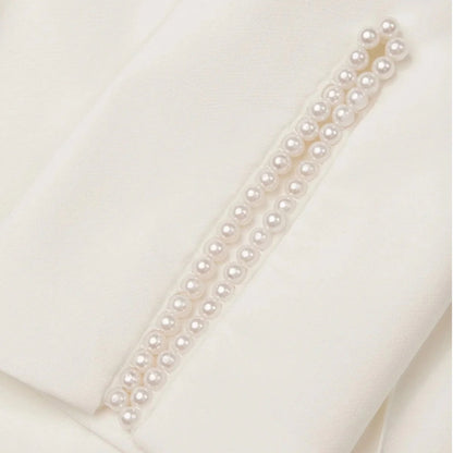 Chic women's tailored jumpsuit with pearl cuffs, a modern and sophisticated choice for evening fashion.