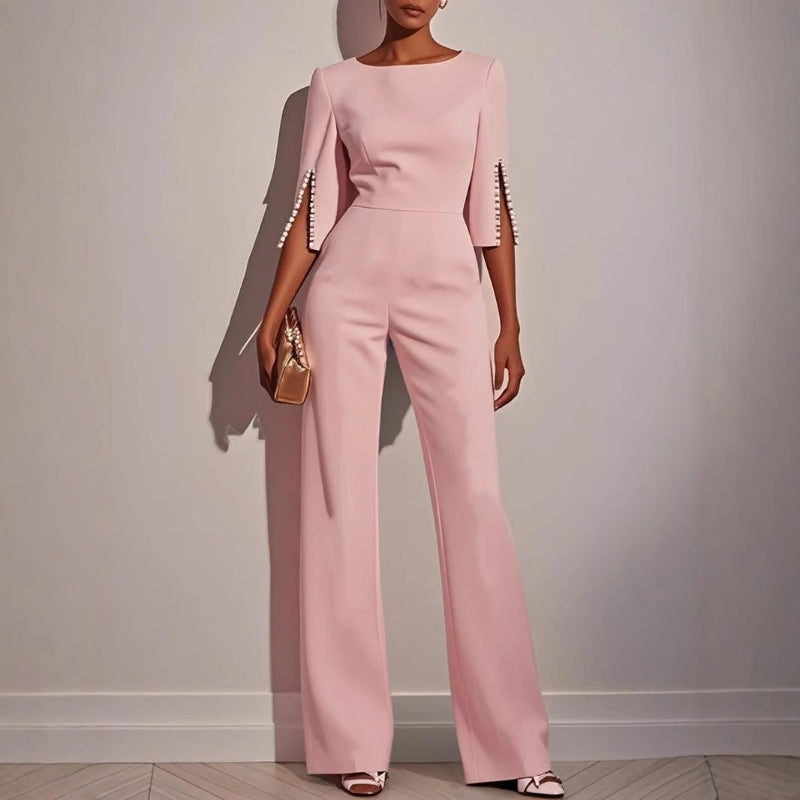 Modern women's elegant tailored jumpsuit with pearl cuffs, a chic and formal option for any special evening.