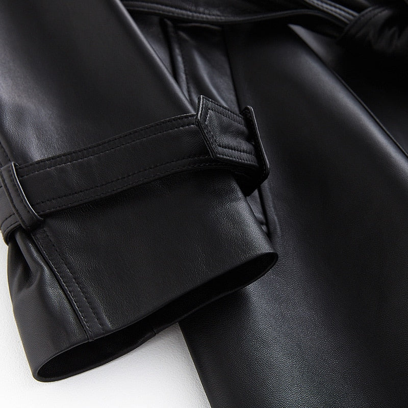 Fashionable women's black trench coat, a sophisticated and versatile long outerwear piece for modern chic style.