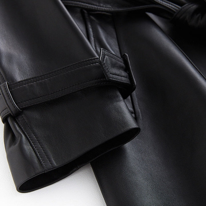 Fashionable women's black trench coat, a sophisticated and versatile long outerwear piece for modern chic style.