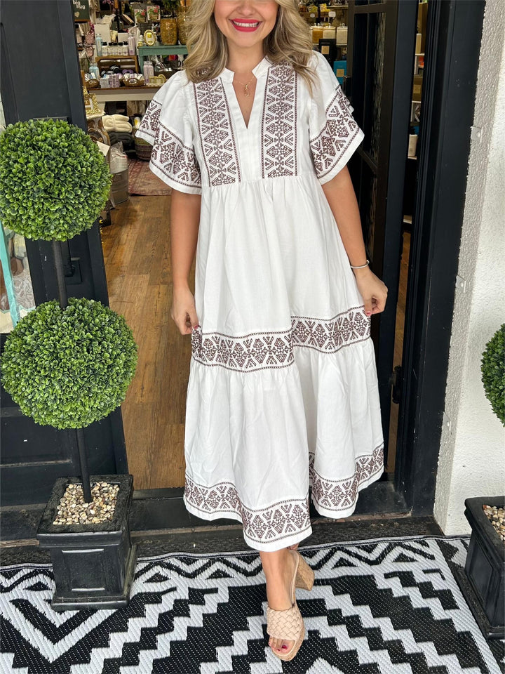 Close-up of elegant embroidery on a women's boho midi dress, highlighting intricate details and style.