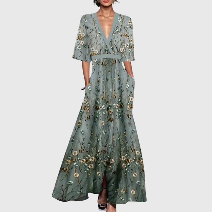 Colorful flowy floral maxi dress for women, featuring a deep V-neck. Ideal as a summer party or elegant guest dress.