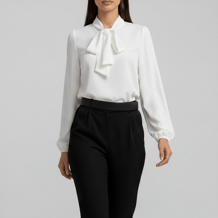 Elegant women's blouse with a classic bow tie neck and fashion-forward puff sleeves for a chic look.