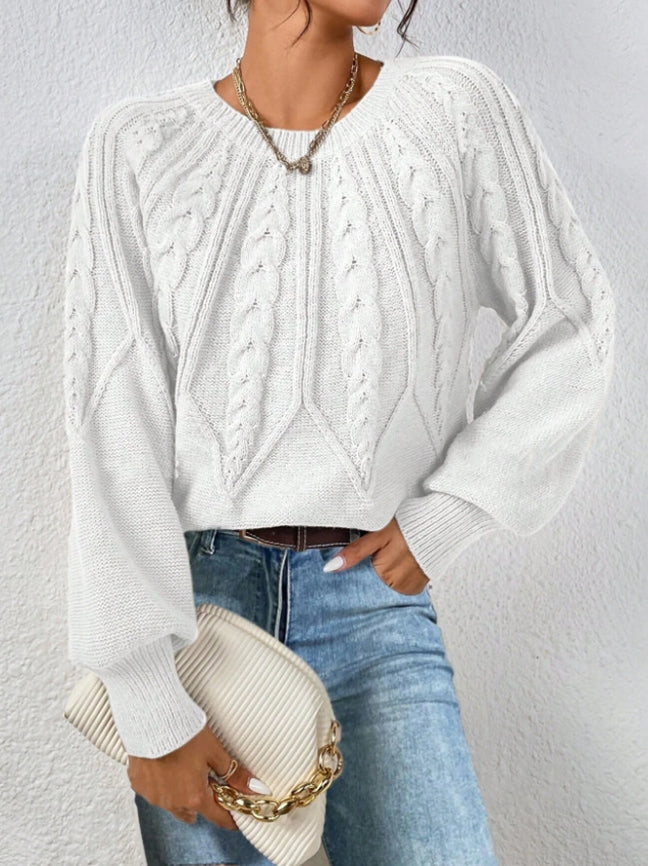 Cozy women's knitwear: elegant cable knit sweater with fashionable balloon sleeves.