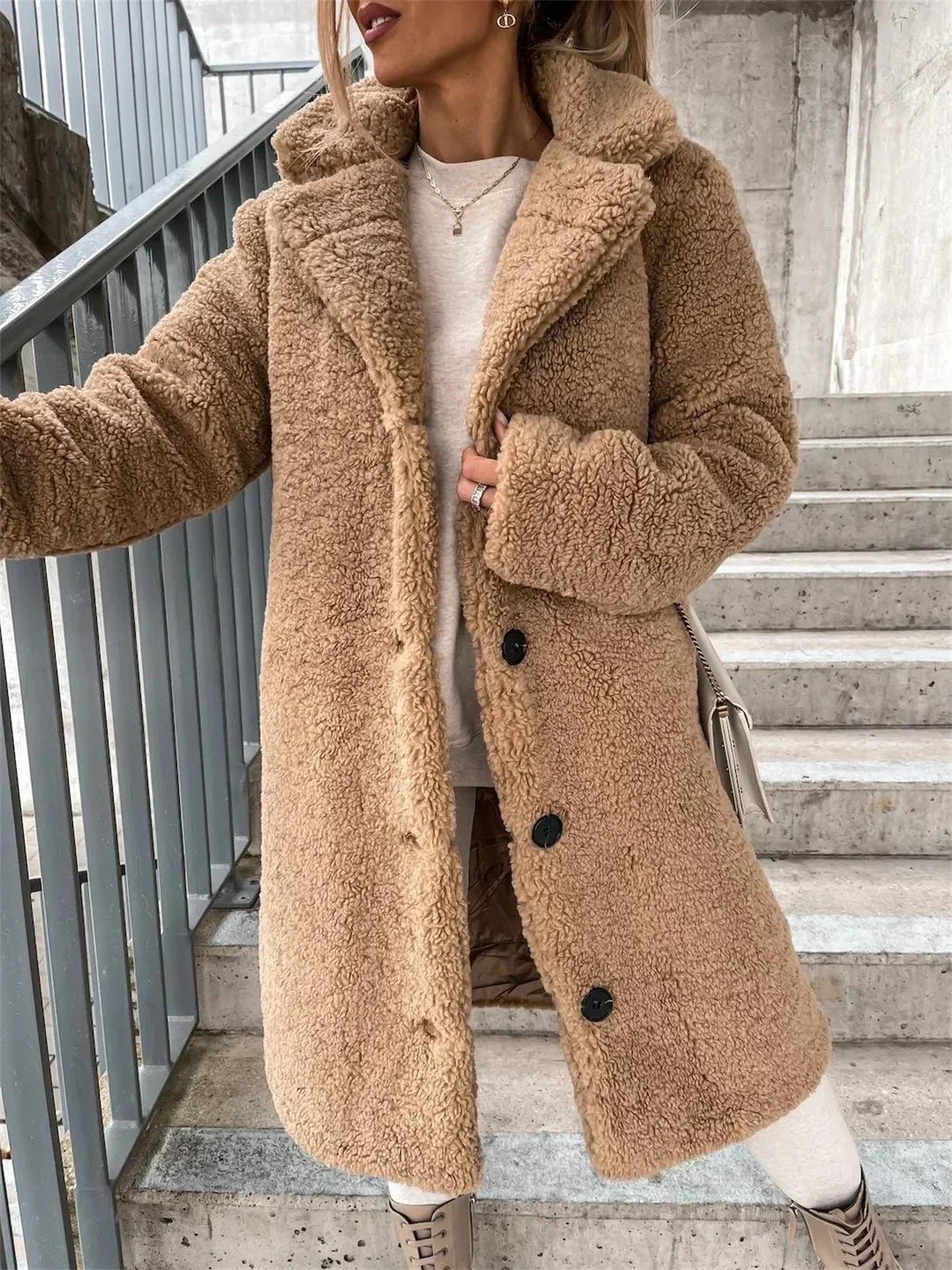 Stylish women's long casual coat with a relaxed fit and elegant button closure, perfect outerwear.