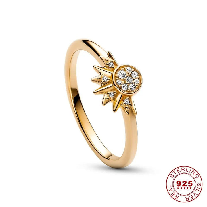 Close-up of a women's hand wearing a shimmering celestial sun moon ring with crystal accents.