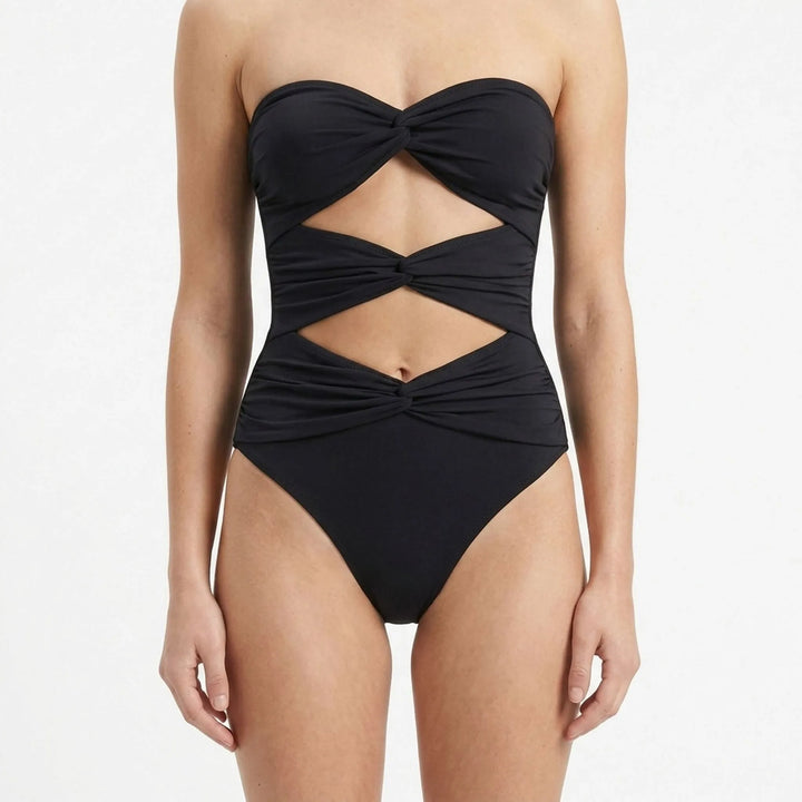 Women's designer cutout swimsuit and flowing skirt resort set, luxurious vacation wear.