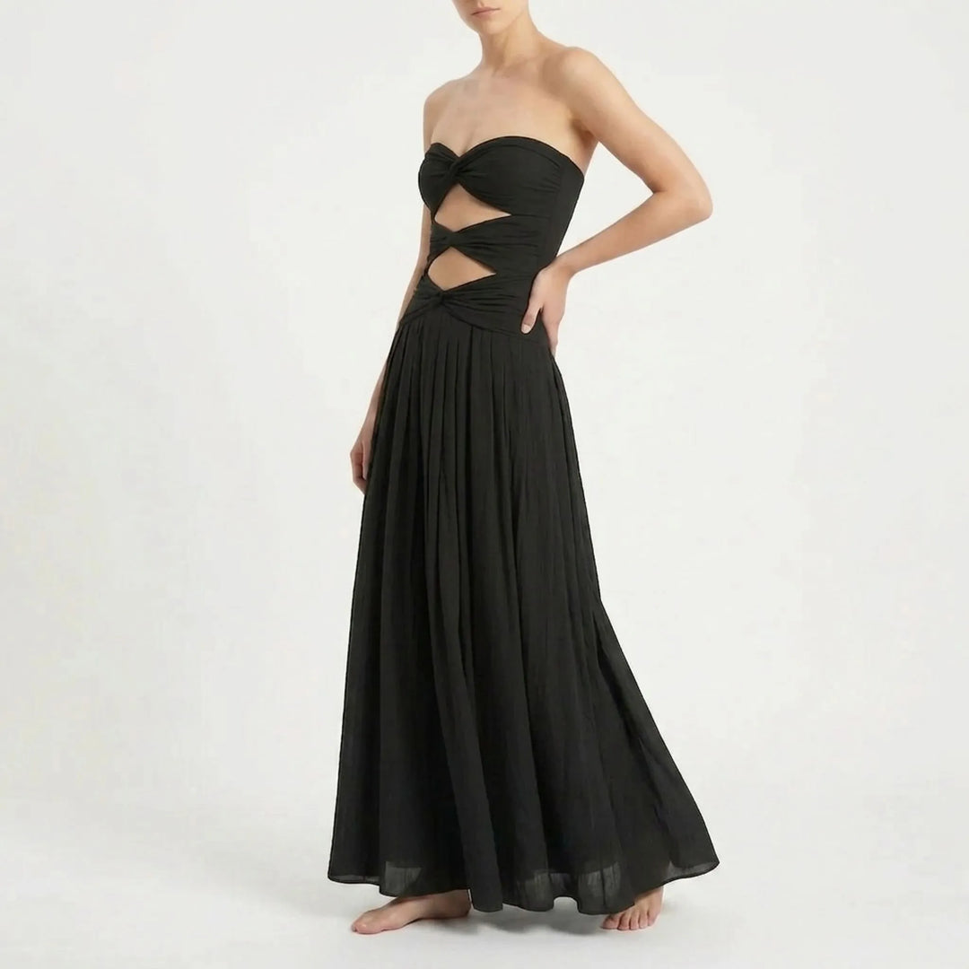 Beautiful women's two-piece cutout swimsuit and flowing skirt, ideal for summer resorts.
