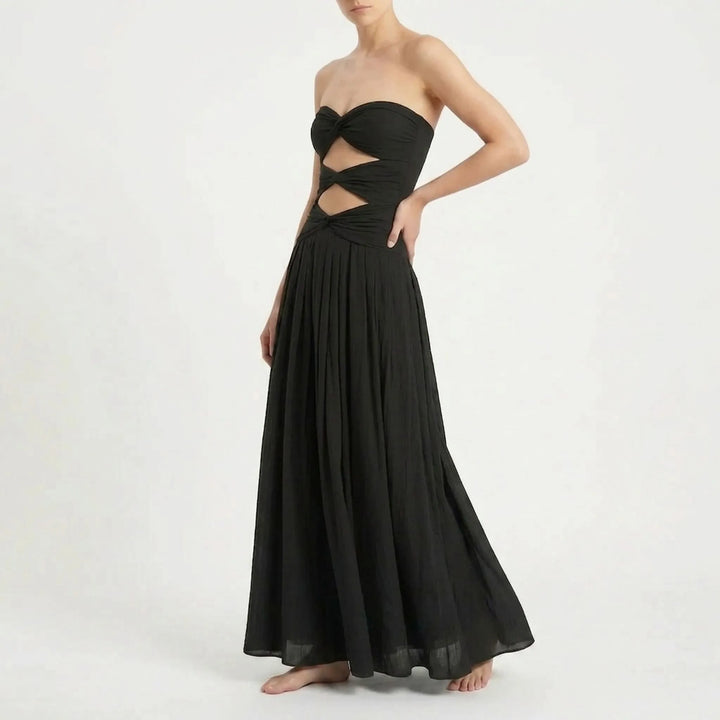 Beautiful women's two-piece cutout swimsuit and flowing skirt, ideal for summer resorts.