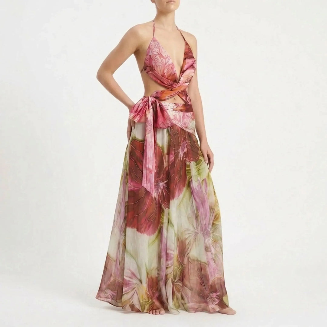 Tropical women's cutout swimsuit with a long flowing skirt, perfect for beach outings.