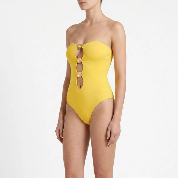 Women's cutout beach set: swimsuit top, flowing skirt, and starfish details for an elegant look.
